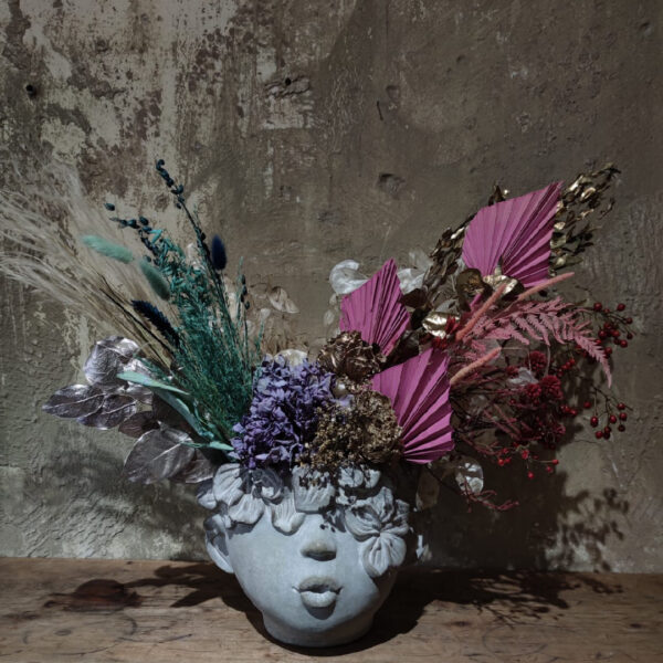 Composition on a vase with half a head
